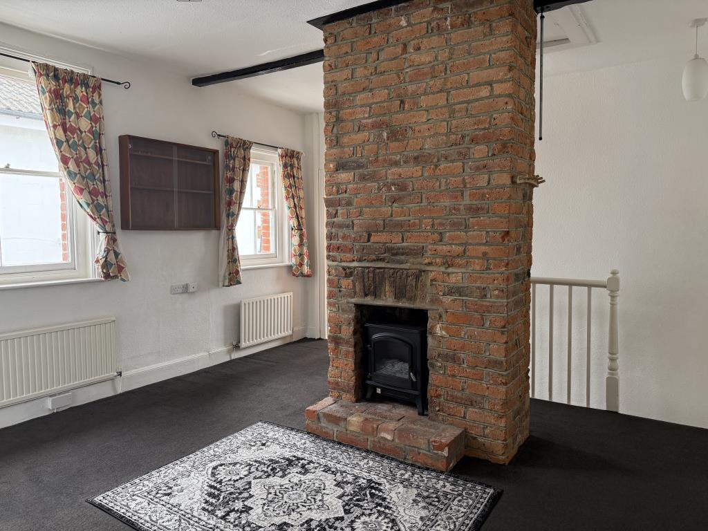 Lot: 142 - ONE-BEDROOM FLAT - Living room with feature fireplace